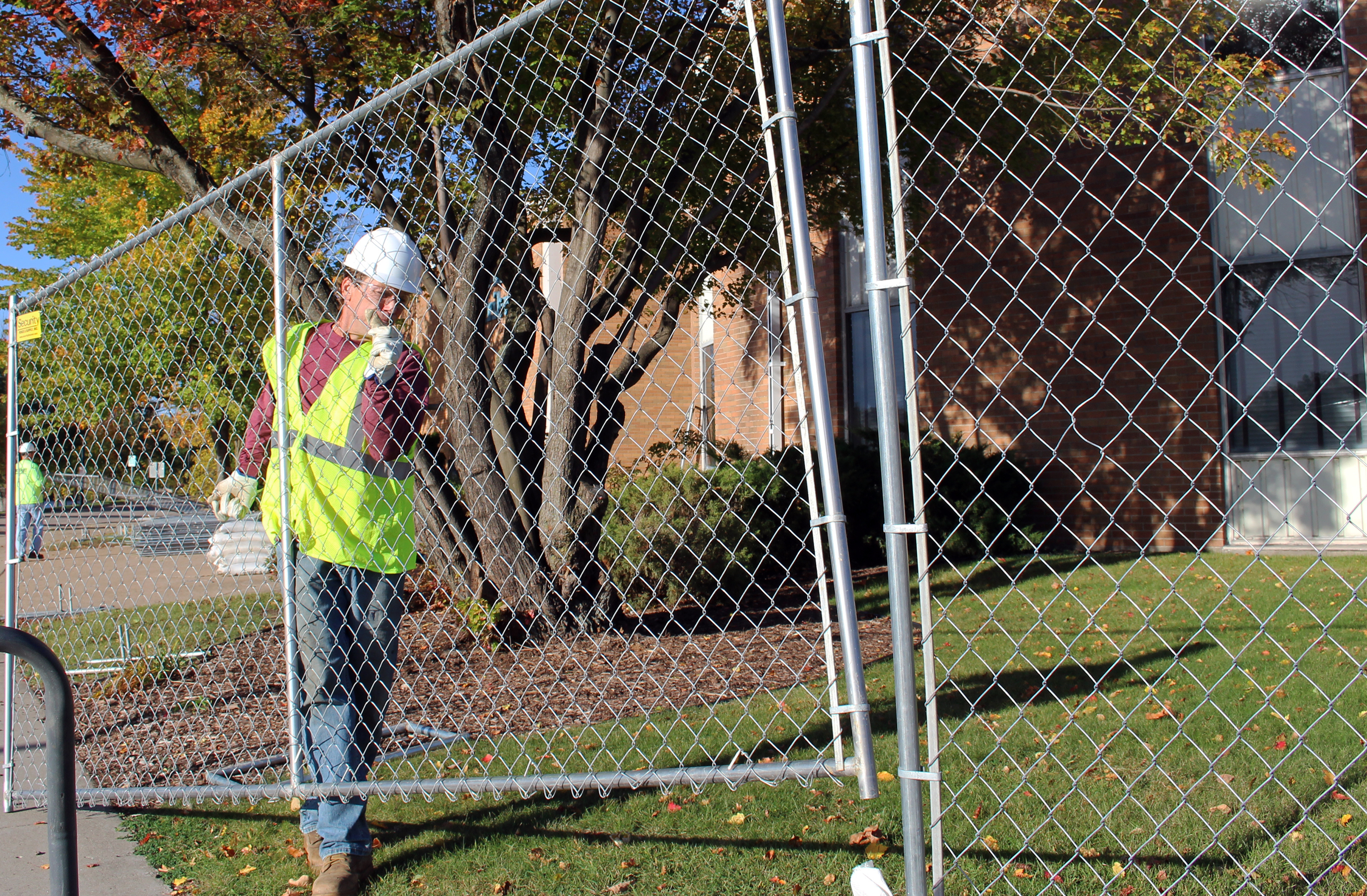 Findorff erects the fence around the building's perimeter.