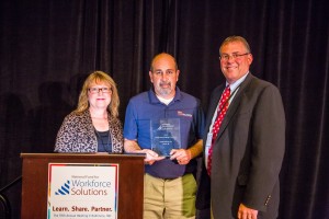 Pointe Precision staff receiving award at annual NFSW national conference in Baltimore. Pictured from left to right: Bonnie Meddaugh (Human Resources Manager), Ron Polum (Director of Operations), and Joe Kinsella (President/CEO). (photo credit:  Don Napoleon, NCP Photography and the National Fund for Workforce Solutions)