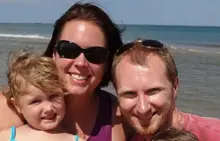 Family smiling at the beach