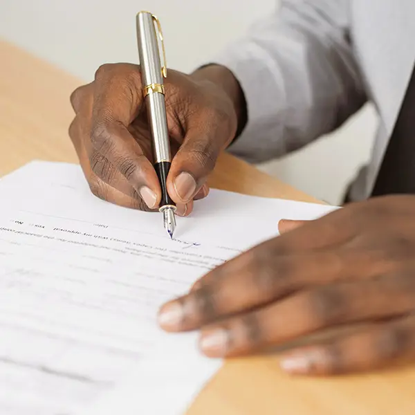 Close up of hands filling out form