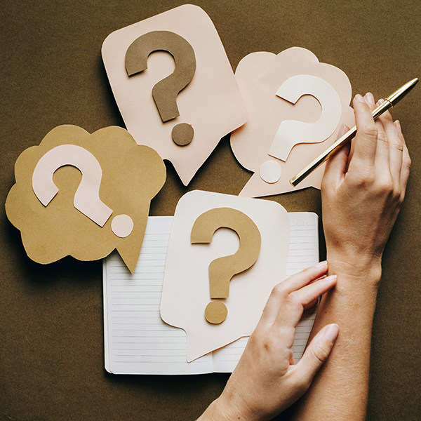 Hands with paper question marks