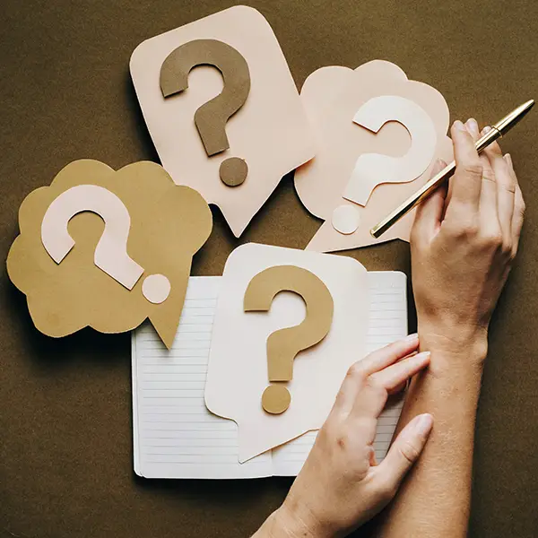 Hands with paper question marks