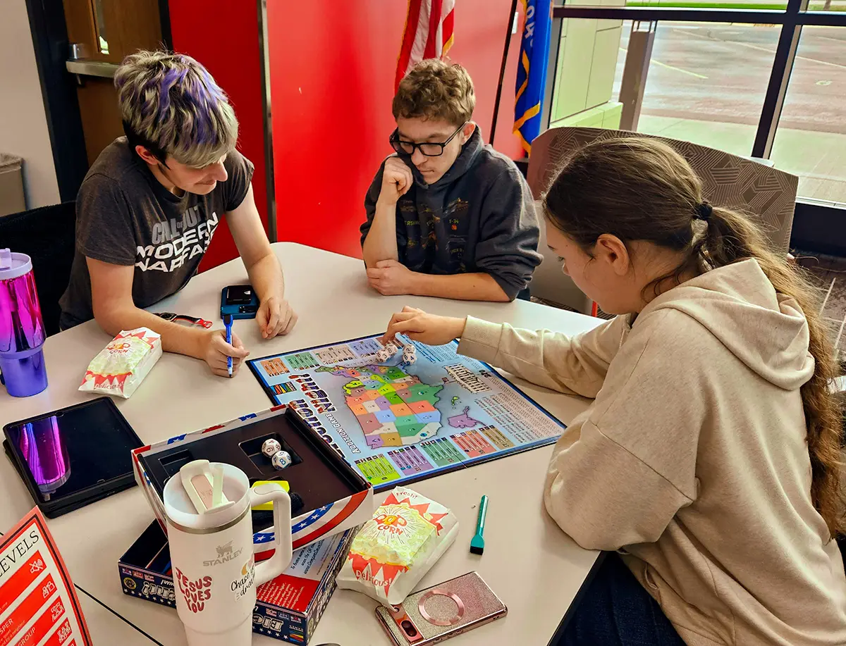 students playing educational board game