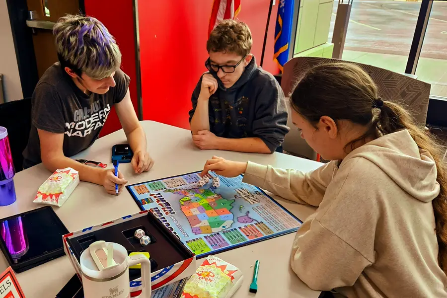 students playing educational board game