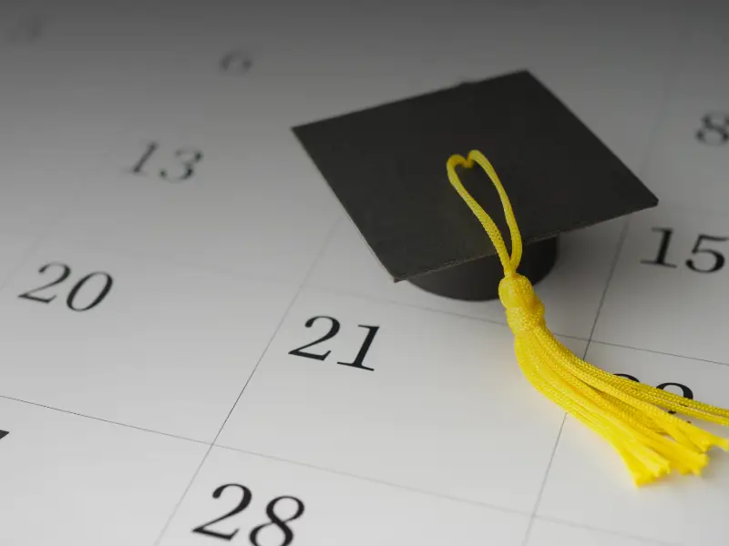 Photo of graduation cap and a calendar